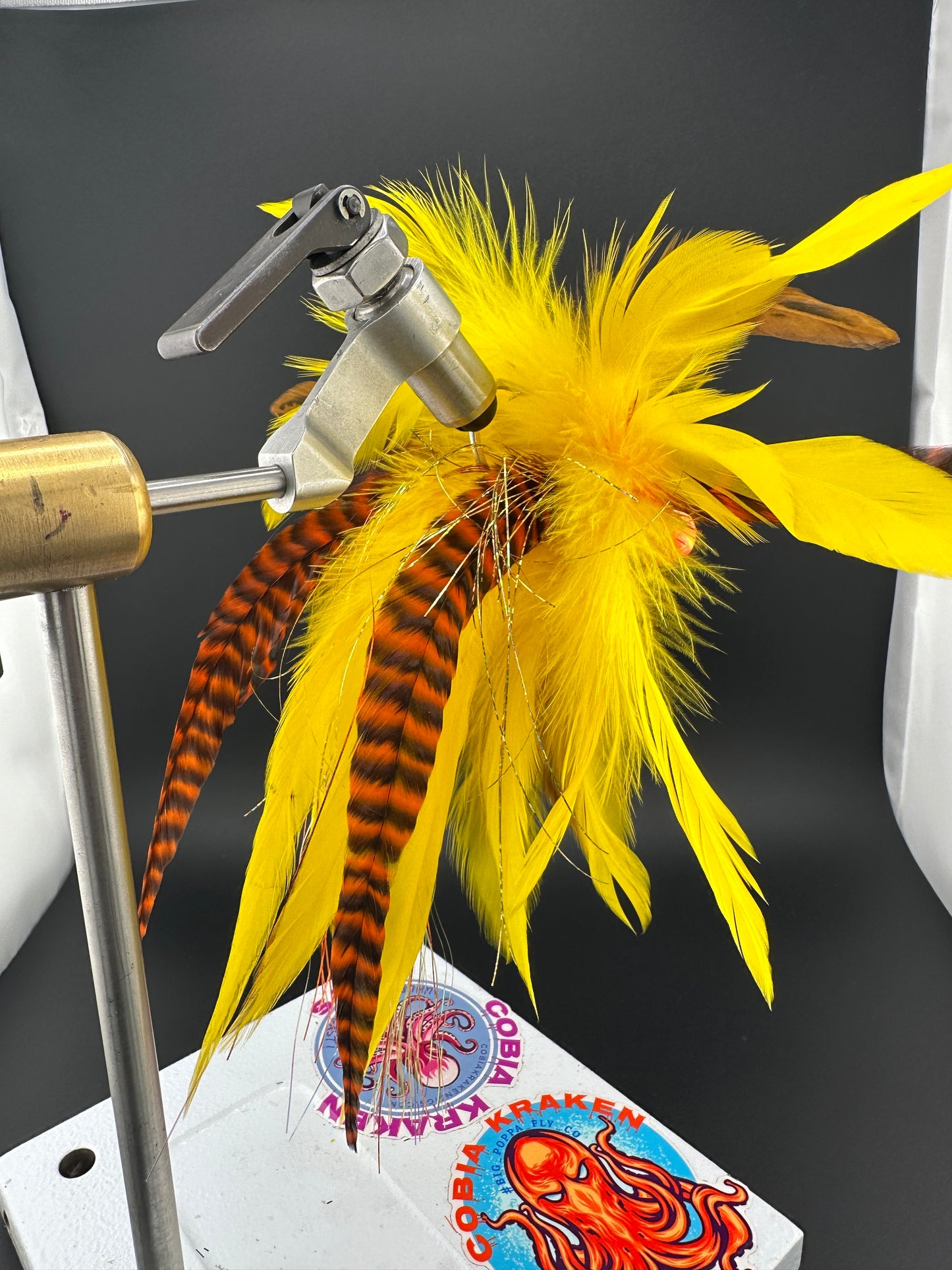 Yellow and orange cobia jig with grizzly tail feathers