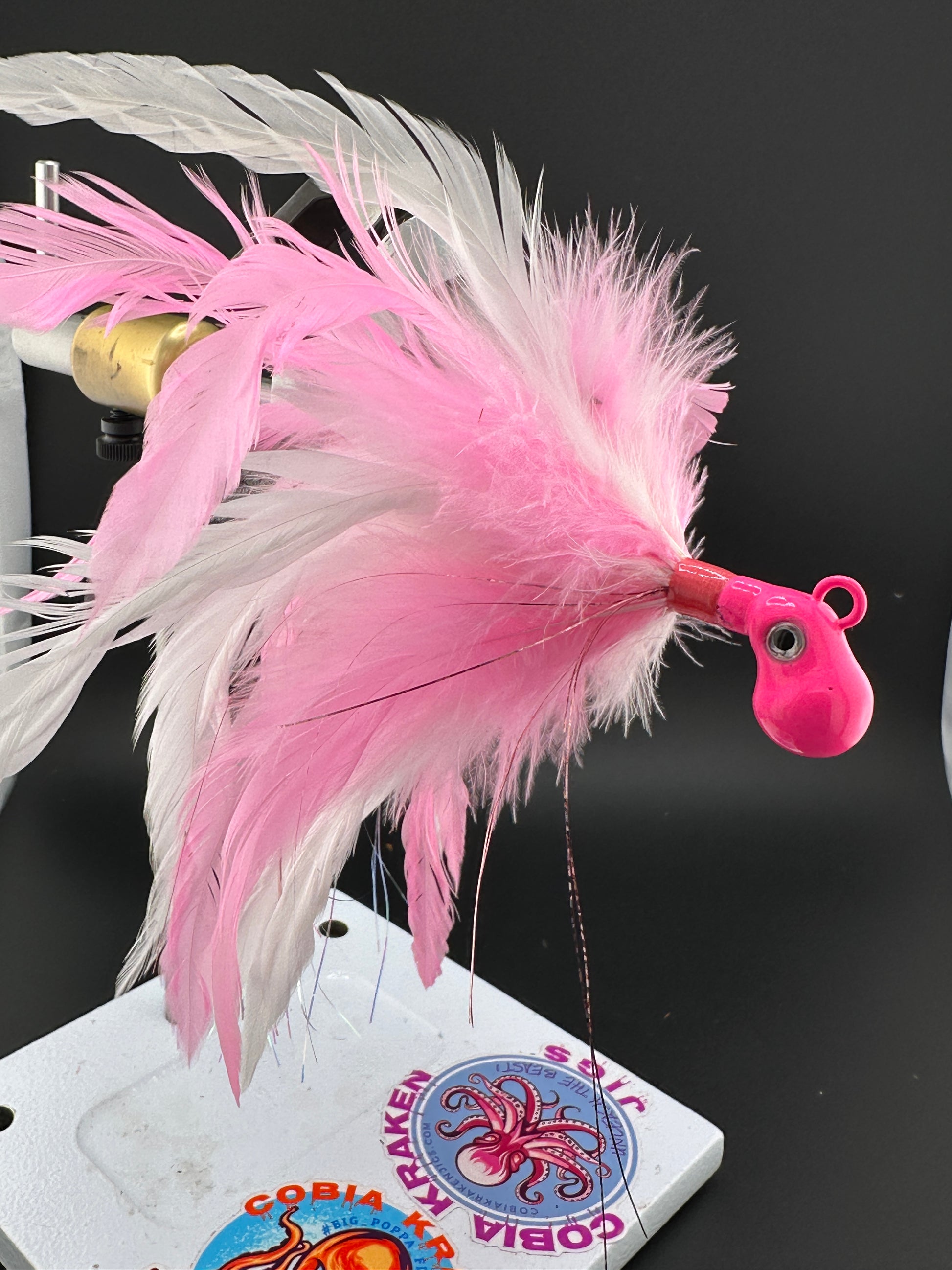 Pink and white saltwater feather jigs by cobiakrakenjigs.com for cobia and tuna fishing