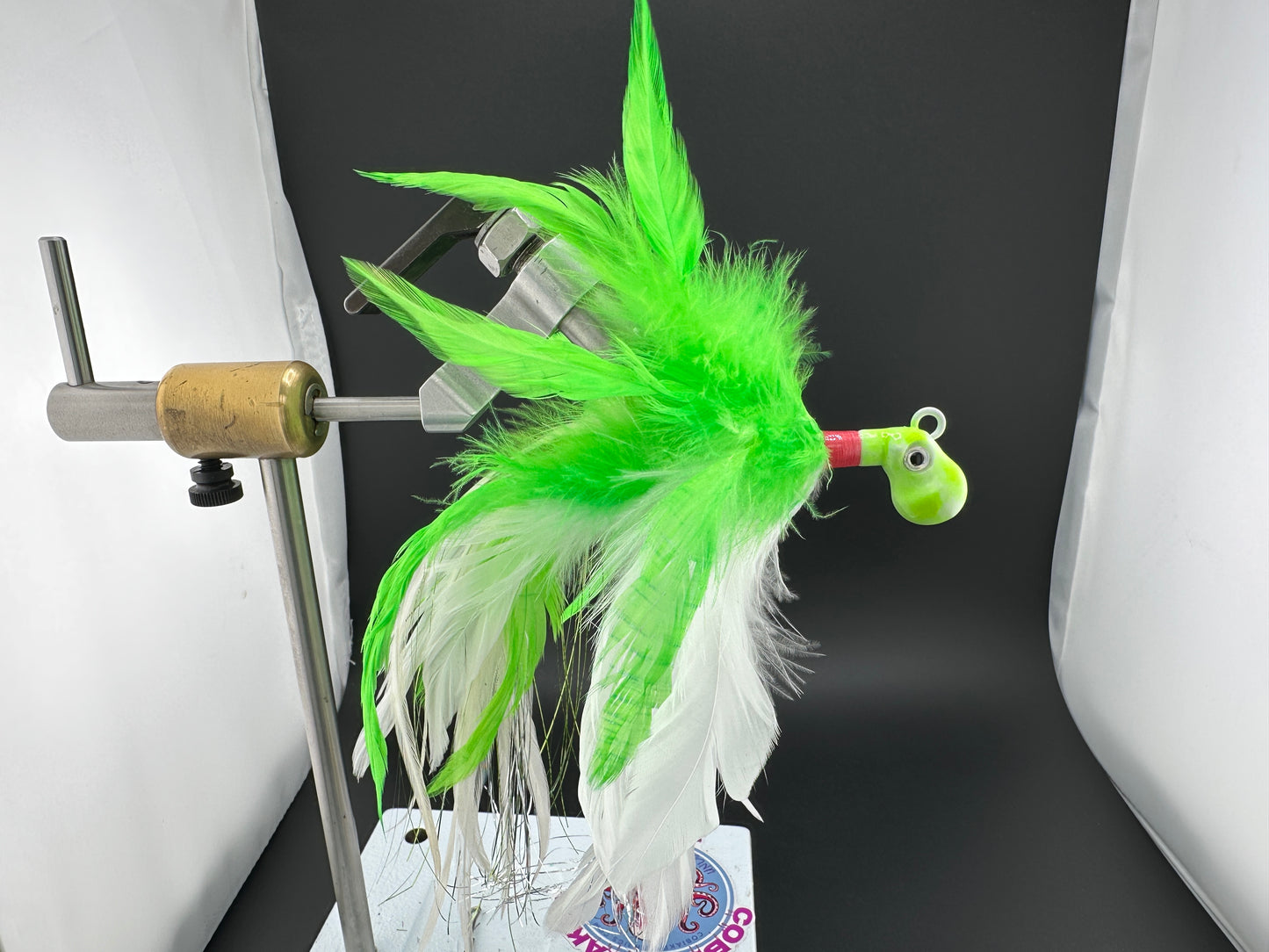 Chartreuse and white saltwater feather jig with octopus head